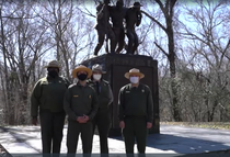National Park Service rangers stand in front of the African American Monument in Vicksburg National Military Park.