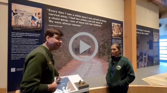 Secretary Haaland and NPS Ranger in front of exhibit at Harriet Tubman Underground Railroad National Historic Park
