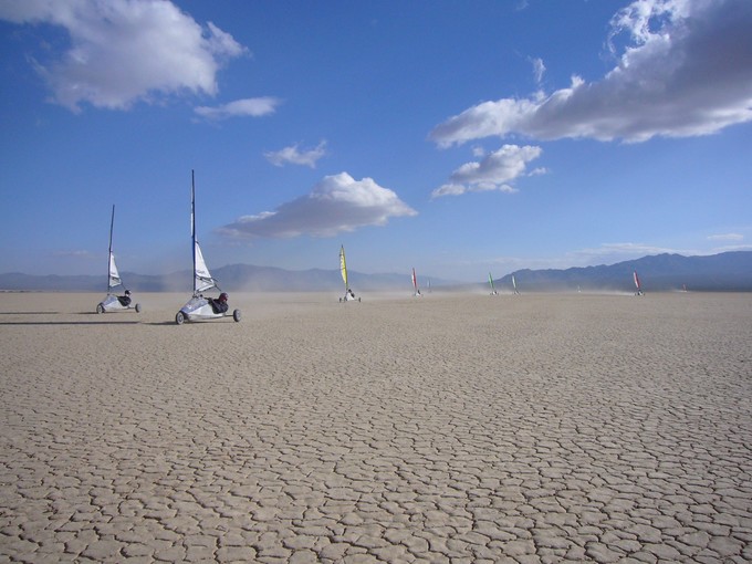 Windsailing vehicles on a dry lake bed.