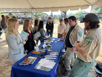 BLM employees talking to students at a booth.