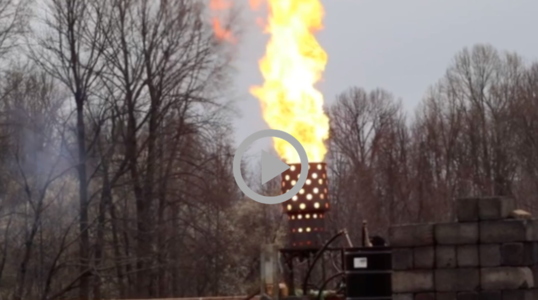 flames belch into the sky as an oil burner ignites  