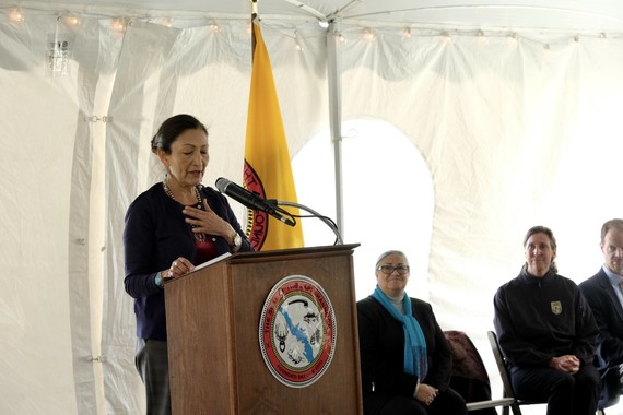 Secretary Haaland speaks into a mic in front of a podium. Photo by DOI.