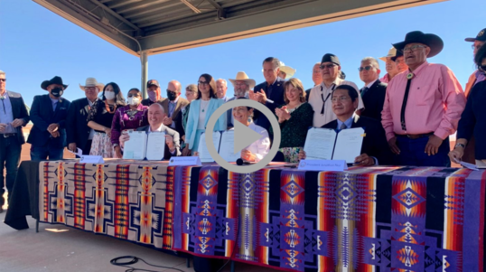 Secretary Haaland holds up water rights agreement at signing ceremony 
