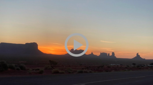 sun sets behind Monument Valley in Utah