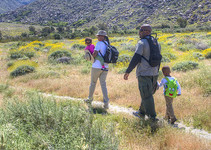 A family walking on a trail.