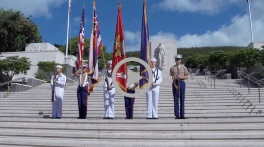 A military color guard stands on the steps at the National Memorial Cemetery of the Pacific