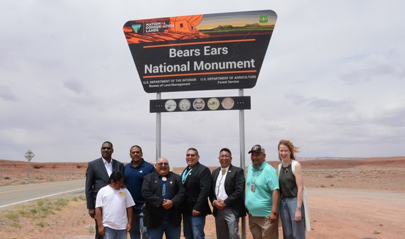 Representatives from the Bears Ears Commission pose for a group photo in front of the Bears Ears National Monument sign