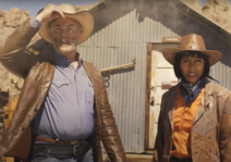 Two people in cowboy hats in western clothes.