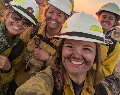 Smiling, smudged, female firefighters. Photo by BLM.