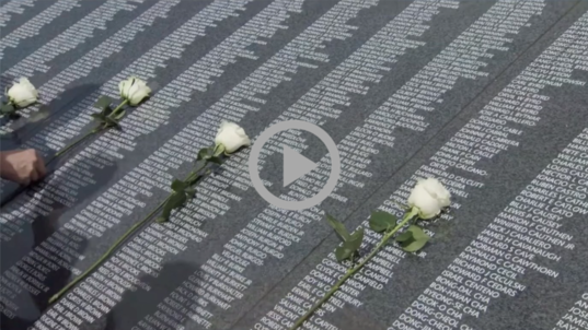 White roses lay atop the columns of names on the Wall of Remembrance at the Korean War Veterans Memorial