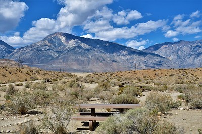 A campground with a picnic table in a high desert.