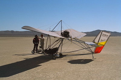 An ultralight aircraft on a dry lakebed.