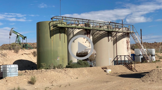 Rusting storage tanks at the site of an abandoned oil well in New Mexico