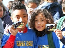 Two boys holding 4th grade passes.