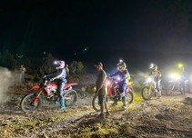 Motorcycle riders in a night race at Fort Sage.