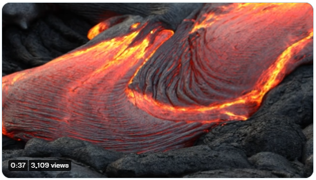 Video of red and yellow lava flowing out of a volcano