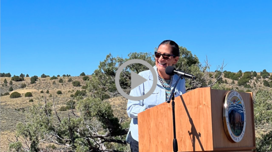 Secretary Haaland standing behind a podium at Rio Grande del Norte National Monument on Public Lands Day