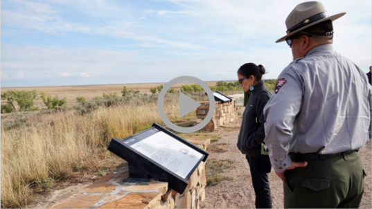 Secretary Haaland and NPS Director Sams read a historic marker near the site of the 1864 massacre