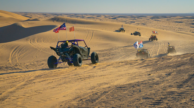 Dune buggies on sand dunes.