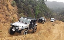 Jeeps driving on an off-road course.