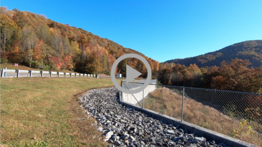 Colorful autumn hills surround the site of a reclaimed coal mine in Kentucky