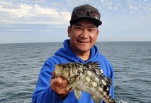 A man holding a fish.