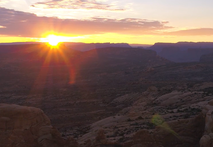 Desert expanse of boulders and mesas at sunset. 