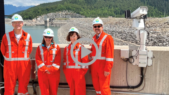 Group photo featuring Liz Klein wearing a hardhat and protective suit