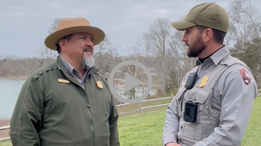 National Park Service Director Chuck Sams speaks to an NPS Law Enforcement Officer.  