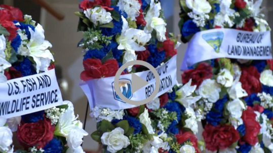 Flowered wreaths sit side by side, representing each of Interior’s law enforcement agencies and the officers who serve there.