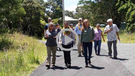 Secretary Haaland, USGS Director David Applegate and others walk along a path at Keauhou Bird Conservation Center.