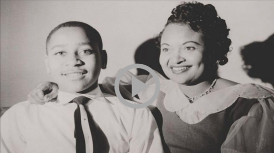 Black and white archival photo of Emmett Till with his mother, Mamie Till-Mobley.