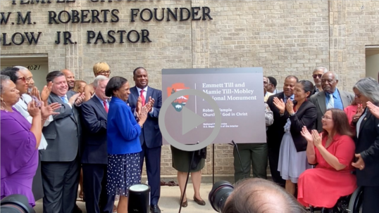 Secretary Haaland stands and applauds with federal, state, and community members as a sign is unveiled at Emmett Till and Mamie Till-Mobley Monument. 