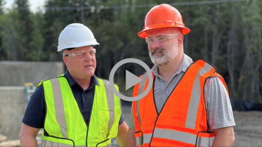 Deputy Secretary Tommy Beaudreau stands with White House Infrastructure Implementation Coordinator Mitch Landrieu at a construction site.