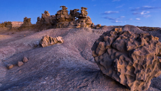 Moonlight illuminates the surreal rock formations that have eroded the sandstone into deep grooves in the rock. 