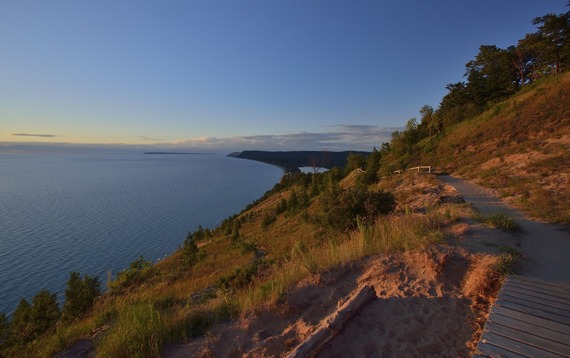 A view of the Empire Bluffs Trail Overlook at Sleeping Bear Dunes National Lakeshore during sunset
