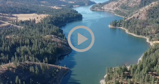 An aerial view of the Upper Columbia River flowing through a landscape of hills and evergreens.
