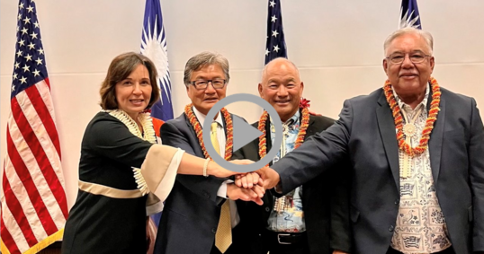 Assistant Secretary for Insular and International Affairs Cantor clasps the hands of representatives of the Republic of the Marshall Islands.