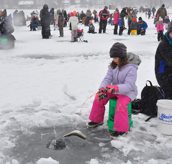 Young lady ice fishing