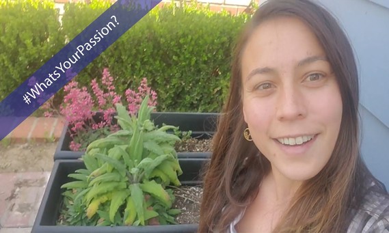 A woman posing near two potted plants