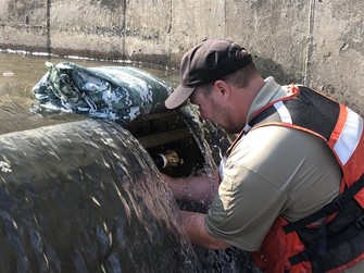FWS employee working on Sea Lamprey control at a barrier