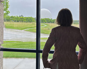 Photo of Anniken Krutnes, Norwegian Ambassador, at the EROS Center looking out at the radome