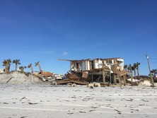 A hurricane-damaged house on a Florida beach