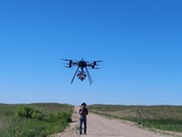 Drone flies over grasslands