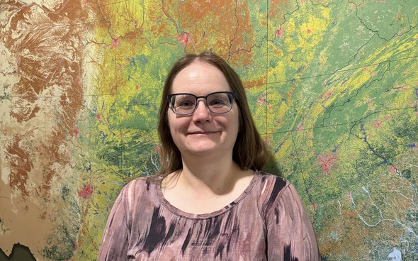Portrait of woman standing in front of map