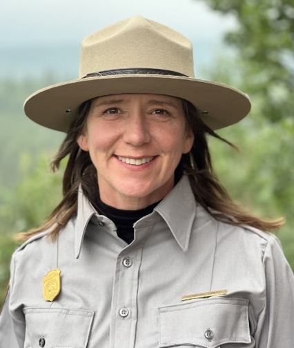 Woman wearing a ranger uniform and flat hat outdoors