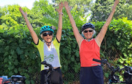 ERCA_enews_Two women raise their arms to celebrate their cycling accomplishment