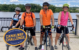 ERCA_Canalway Challenge: 4 cyclists pose in front of the waterway