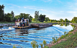 ERCA: A tug pushes a barge on the Erie Canal