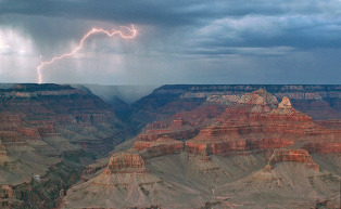 lightning and rain across an enormous canyon